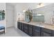 Double vanity bathroom with granite countertops and a large mirror at 5014 E Fountainwood Dr, Saint Cloud, FL 34772