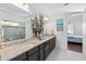 Double vanity bathroom with granite countertops and view to bedroom at 5014 E Fountainwood Dr, Saint Cloud, FL 34772