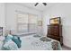 Bright bedroom with a queen bed and dresser at 5014 E Fountainwood Dr, Saint Cloud, FL 34772