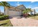 Brick paved driveway leading to a two-car garage at 5014 E Fountainwood Dr, Saint Cloud, FL 34772
