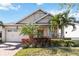 Single-story home with a welcoming porch and attractive facade at 5014 E Fountainwood Dr, Saint Cloud, FL 34772