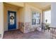 Inviting front porch with blue door and stone accents at 5014 E Fountainwood Dr, Saint Cloud, FL 34772