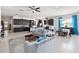 Open living space with gray sofas and teal curtains at 5014 E Fountainwood Dr, Saint Cloud, FL 34772