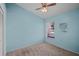 Simple bedroom featuring light blue walls and a ceiling fan at 5137 Martinique Dr, Lakeland, FL 33812