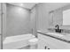 Bathroom with granite countertop and tiled shower at 534 Bristol Cir, Kissimmee, FL 34758