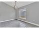 Bright dining area with grey tile floors and modern light fixture at 534 Bristol Cir, Kissimmee, FL 34758