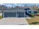 House exterior showcasing a two-car garage and well-manicured lawn at 534 Bristol Cir, Kissimmee, FL 34758