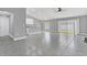 Open living room and kitchen area with grey tile floors and vaulted ceilings at 534 Bristol Cir, Kissimmee, FL 34758