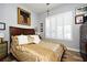 Spacious bedroom with gold bedding and plantation shutters at 601 Sycamore St # 6108, Celebration, FL 34747