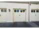 Attached garage with white doors and exterior lighting at 601 Sycamore St # 6108, Celebration, FL 34747