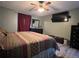 Large bedroom with king bed and mounted TV at 648 Tradewinds Dr, Deltona, FL 32738