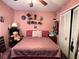 Bedroom with a full-size bed and pink walls at 648 Tradewinds Dr, Deltona, FL 32738