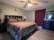 Spacious bedroom with king-size bed and ceiling fan at 648 Tradewinds Dr, Deltona, FL 32738