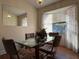 Bright dining area with glass table and four chairs at 648 Tradewinds Dr, Deltona, FL 32738