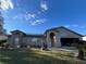 Brick house with a two-car garage and solar panels at 648 Tradewinds Dr, Deltona, FL 32738