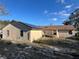 Rear view of house with solar panels and a yard at 648 Tradewinds Dr, Deltona, FL 32738