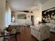 Spacious living room with ample seating and wood floors at 648 Tradewinds Dr, Deltona, FL 32738