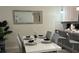 Well-decorated dining area with a modern table setting, accented by a mirror and a glimpse into the adjacent kitchen at 701 Ocean Course Ave, Davenport, FL 33896