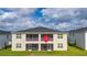 Rear view of townhome showcasing screened patio at 701 Ocean Course Ave, Davenport, FL 33896