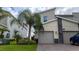 Modern two-story home with attached two-car garage and landscaping at 701 Ocean Course Ave, Davenport, FL 33896