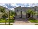 Two-story townhome with two-car garage and landscaped front yard at 701 Ocean Course Ave, Davenport, FL 33896