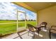 Cozy screened patio overlooking a lush green space at 701 Ocean Course Ave, Davenport, FL 33896