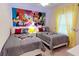 Mickey Mouse themed bedroom with two twin beds and bright yellow curtains at 8906 Shine Dr, Kissimmee, FL 34747