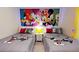 Mickey Mouse themed bedroom with two twin beds, nightstands, and bright wall art at 8906 Shine Dr, Kissimmee, FL 34747