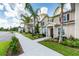 Exterior view of townhouses with landscaping and walkway at 8906 Shine Dr, Kissimmee, FL 34747
