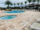 Community pool and spa with plenty of lounge chairs for relaxation at 8906 Shine Dr, Kissimmee, FL 34747