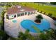 Community pool with a unique shape and plenty of lounge chairs at 8906 Shine Dr, Kissimmee, FL 34747