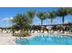 Resort-style pool with palm trees and lounge chairs at 8906 Shine Dr, Kissimmee, FL 34747
