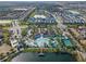 Aerial view showing community amenities including pool, clubhouse, and lake at 8953 Zurich Ln, Kissimmee, FL 34747