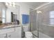 Bathroom with granite countertop, shower, and white cabinets at 8953 Zurich Ln, Kissimmee, FL 34747