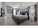 King-size bed in a grey themed bedroom with TV at 8953 Zurich Ln, Kissimmee, FL 34747