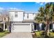 Two-story house with gray siding, stone accents, and a gray garage door at 8953 Zurich Ln, Kissimmee, FL 34747