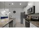 Modern kitchen with stainless steel appliances and granite countertops at 8953 Zurich Ln, Kissimmee, FL 34747