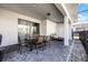 Covered patio with table and chairs, perfect for outdoor dining at 8953 Zurich Ln, Kissimmee, FL 34747