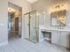 Bathroom featuring glass shower with gold trim, sink, and vanity with storage space at 900 Shorehaven Drive, Poinciana, FL 34759