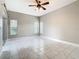Open bedroom with bright windows, neutral walls, and a ceiling fan at 900 Shorehaven Drive, Poinciana, FL 34759
