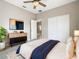 Cozy bedroom featuring TV, dresser, and plant at 900 Shorehaven Drive, Poinciana, FL 34759