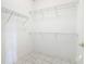 Walk-in closet with wire shelving and tile flooring, offering ample storage space at 900 Shorehaven Drive, Poinciana, FL 34759