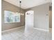 Dining space with a large window for natural light and an open archway to another room at 900 Shorehaven Drive, Poinciana, FL 34759