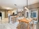 Open concept dining area with tile flooring, and direct access to the backyard through sliding glass doors at 900 Shorehaven Drive, Poinciana, FL 34759