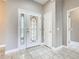Foyer area with decorative front door, tile flooring, and neutral paint colors at 900 Shorehaven Drive, Poinciana, FL 34759