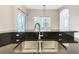 Modern kitchen island with a double sink and stylish faucet at 900 Shorehaven Drive, Poinciana, FL 34759