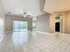 Open-concept living area featuring tile flooring, a ceiling fan, and neutral paint at 900 Shorehaven Drive, Poinciana, FL 34759