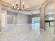 Spacious living area with tile floors, modern lighting, and open access to other rooms and outdoor areas at 900 Shorehaven Drive, Poinciana, FL 34759