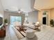 Bright living room with tile flooring, ceiling fan, and sliding glass doors leading to the outdoor space at 900 Shorehaven Drive, Poinciana, FL 34759