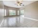 Spacious living room featuring tile floors, natural light, and access to outdoor patio through sliding glass door at 900 Shorehaven Drive, Poinciana, FL 34759